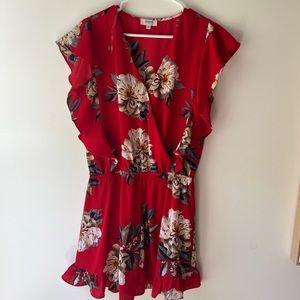 Floral romper in size medium with ruffles on sleeves and shorts